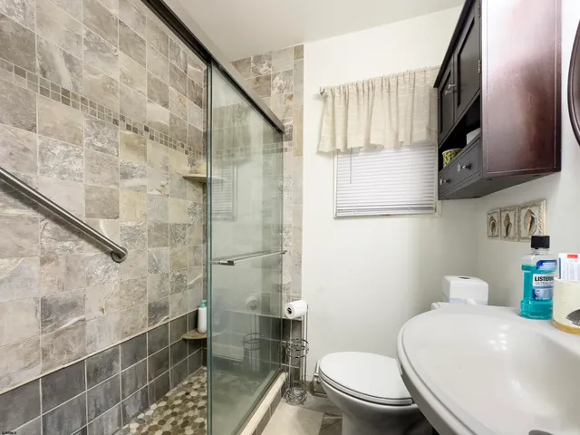 a white toilet sitting next to a bathroom sink