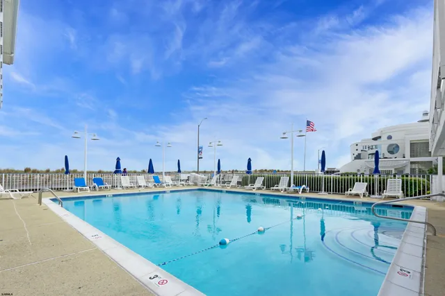 a view of swimming pool with outdoor seating