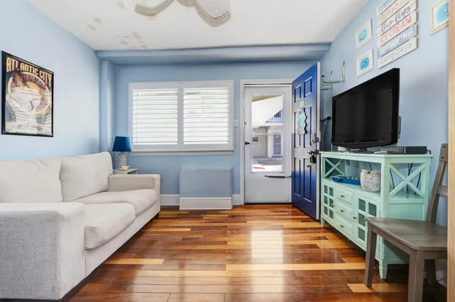 a living room with furniture and a flat screen tv