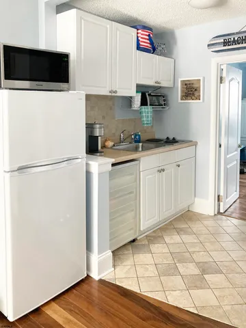 a kitchen with stainless steel appliances a refrigerator a stove a microwave and cabinets