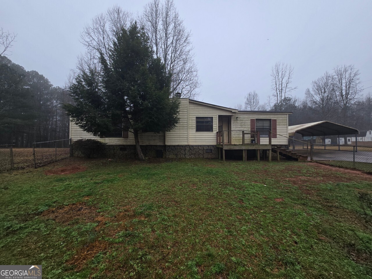 7712 Luthersville Road Gay, GA 30218 - Photo 1 of 1 a view of a house with backyard and sitting area