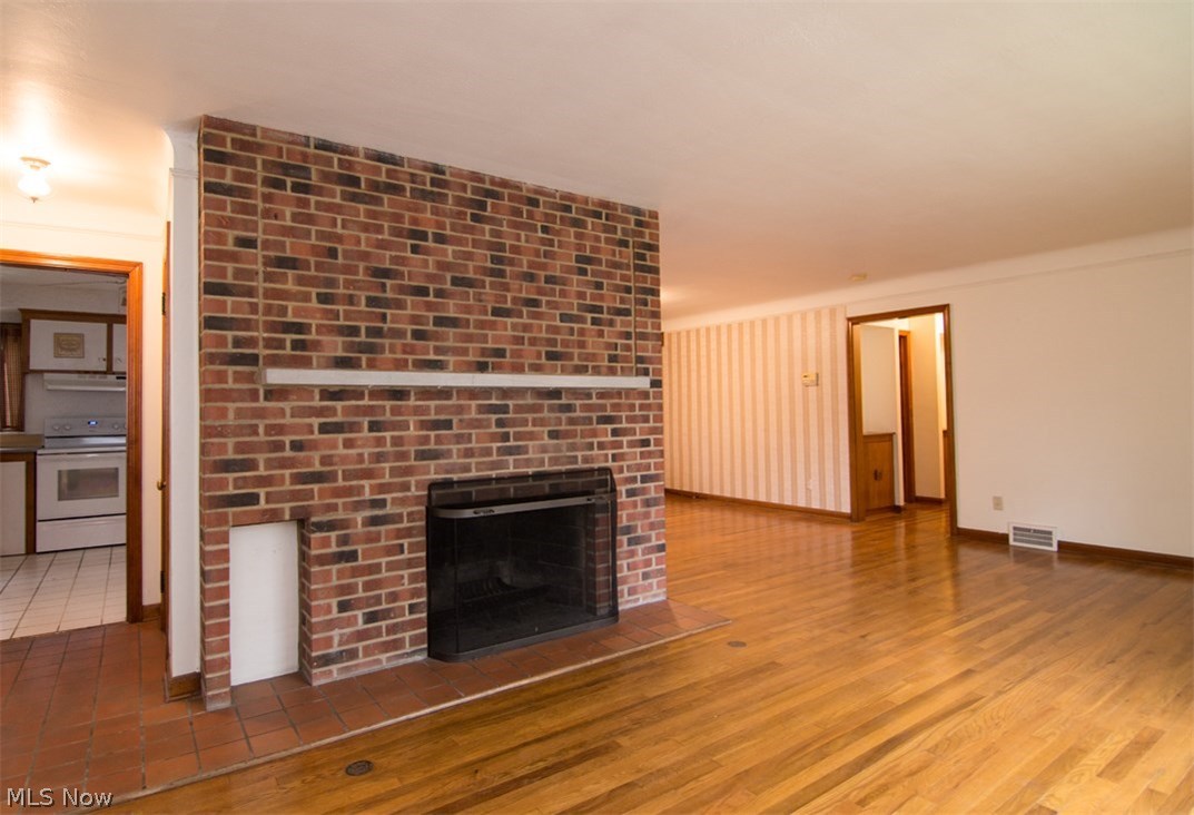 30200 Smithfield Road Chagrin Falls, OH 44022 - Photo 4 of 27 The living room is spacious and features a floor to ceiling brick fireplace.