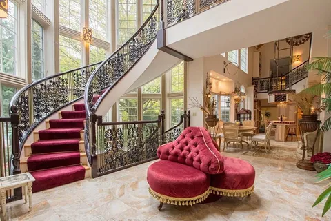 a room with lots of chairs and a potted plant