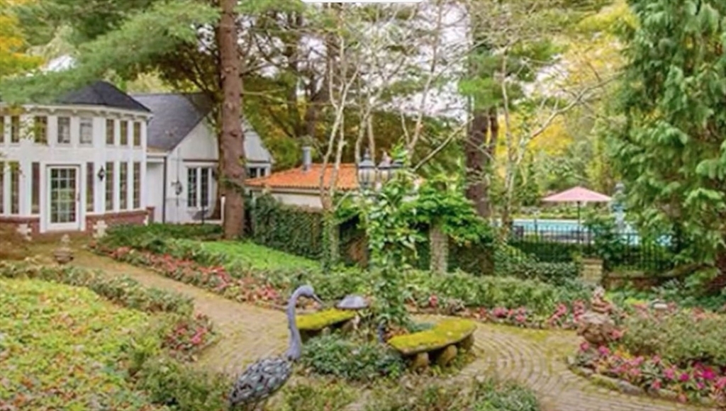 87 East Holland Road Fiskdale, MA 01518 - Photo 4 of 30 a view of a garden with plants and large trees