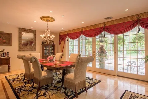 a view of a dining room with furniture wooden floor and chandelier