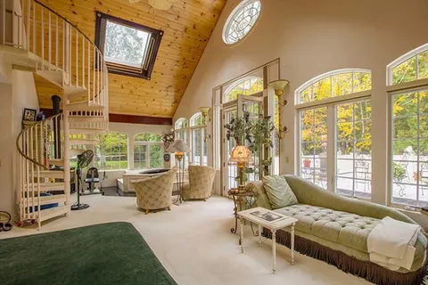 a bedroom with furniture and a large window