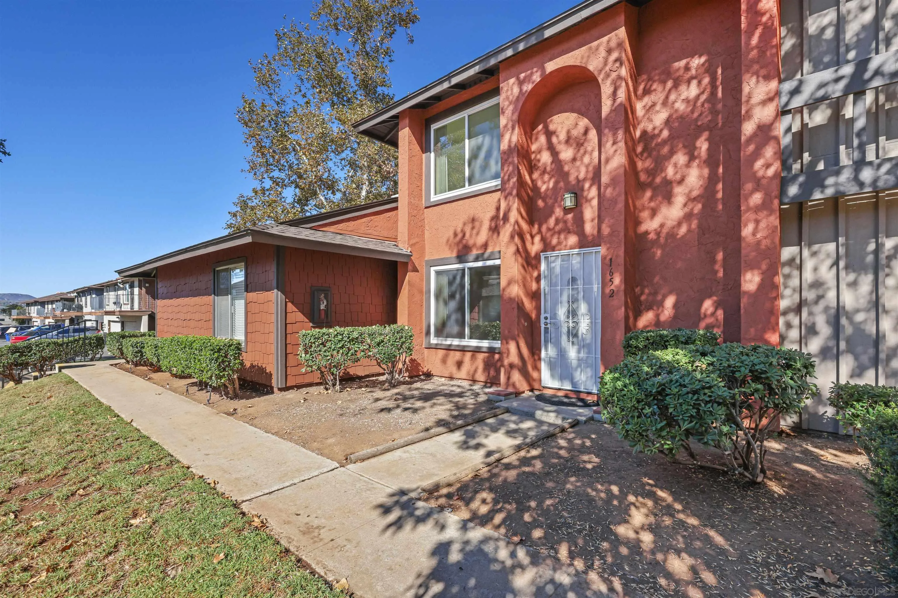 1652 Summertime Drive El Cajon, CA 92021 - Photo 17 of 23 a front view of a house with a yard and potted plants