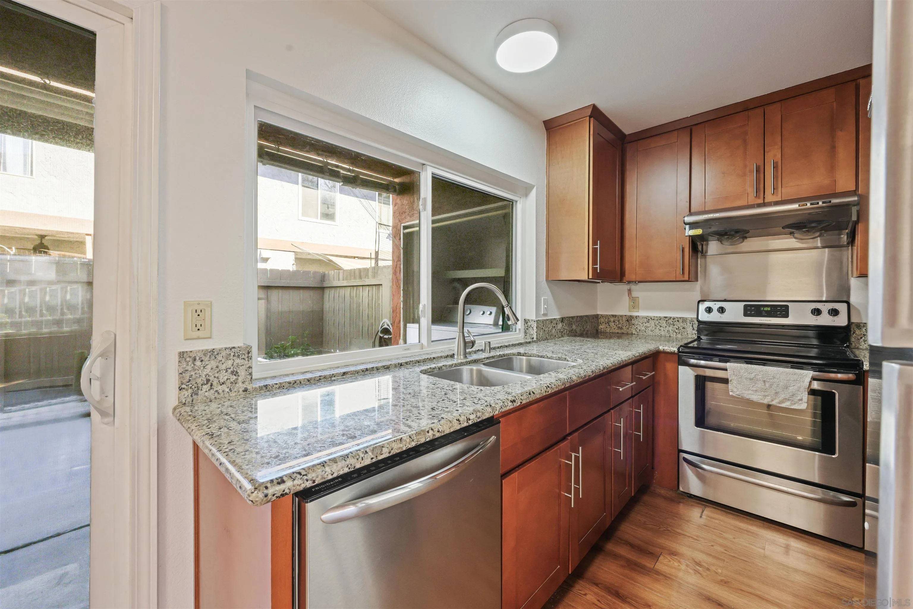 1652 Summertime Drive El Cajon, CA 92021 - Photo 2 of 23 a kitchen with granite countertop stainless steel appliances a sink stove and cabinets