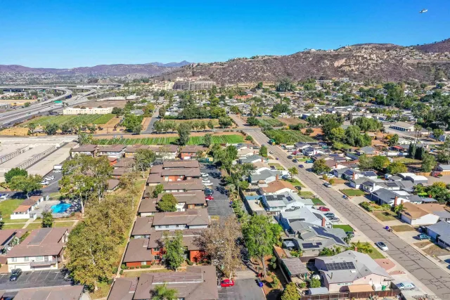 an aerial view of residential houses with outdoor space