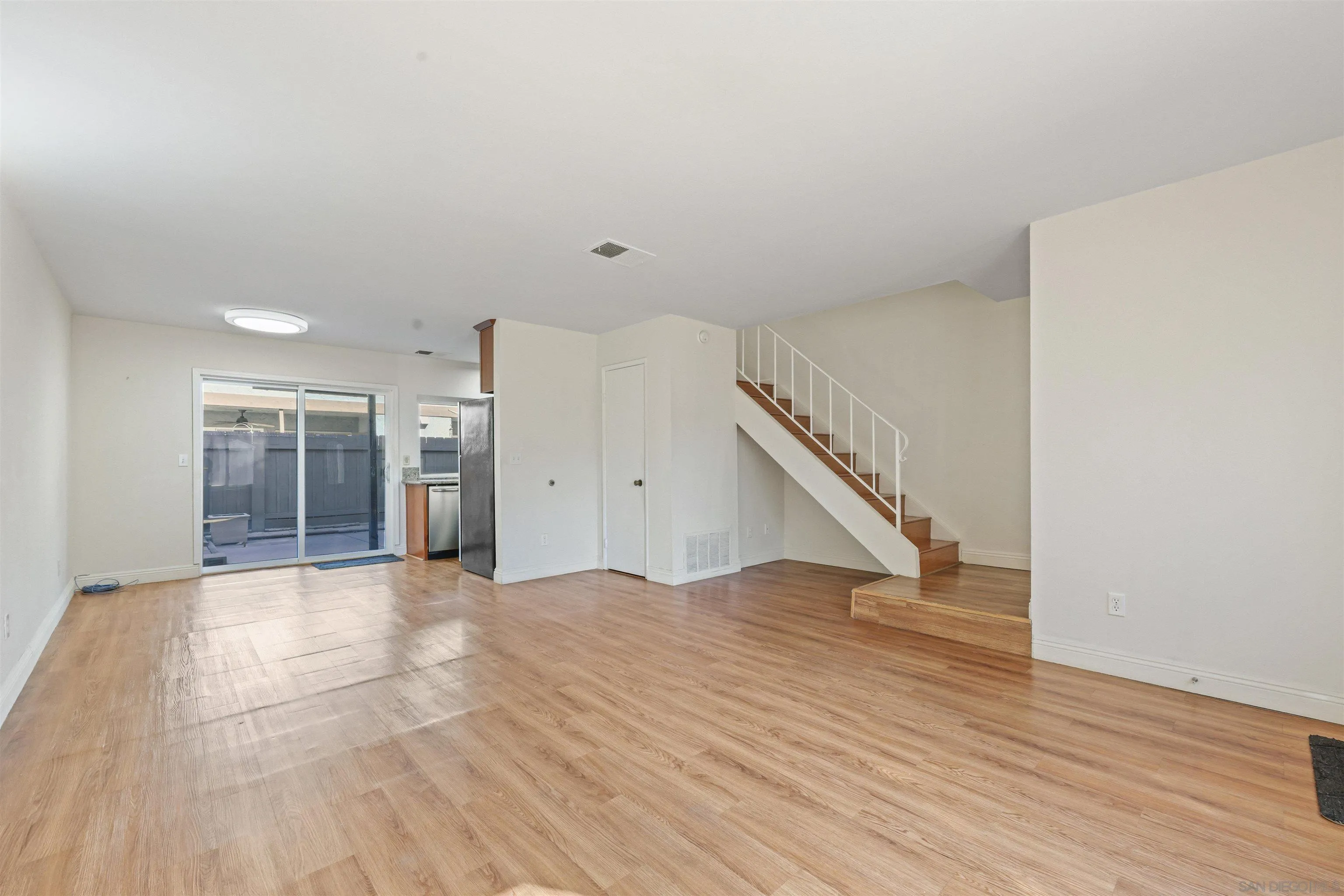 1652 Summertime Drive El Cajon, CA 92021 - Photo 3 of 23 a view of an empty room with wooden floor and stairs