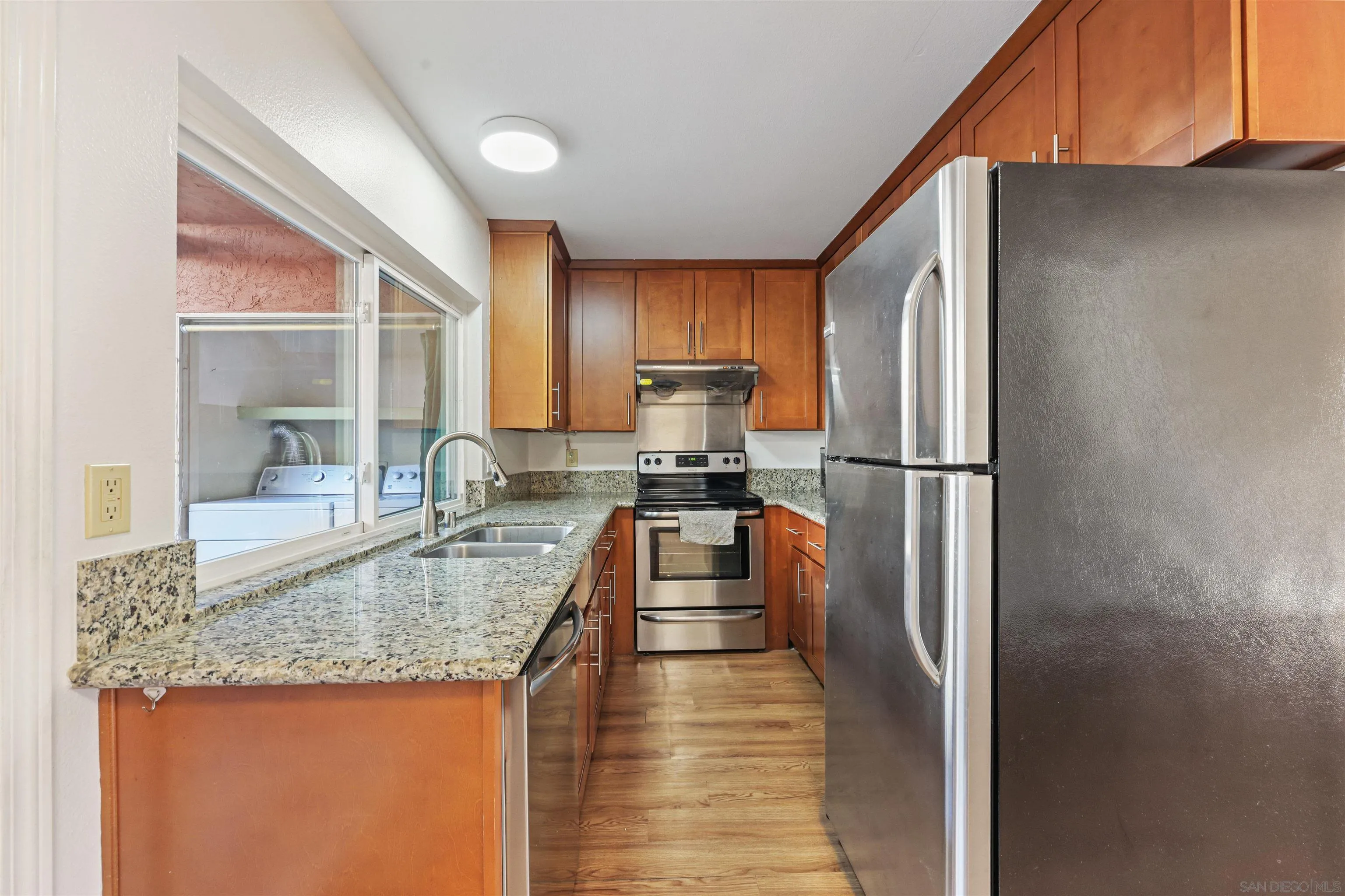 1652 Summertime Drive El Cajon, CA 92021 - Photo 5 of 23 a kitchen with granite countertop a refrigerator a stove and a sink
