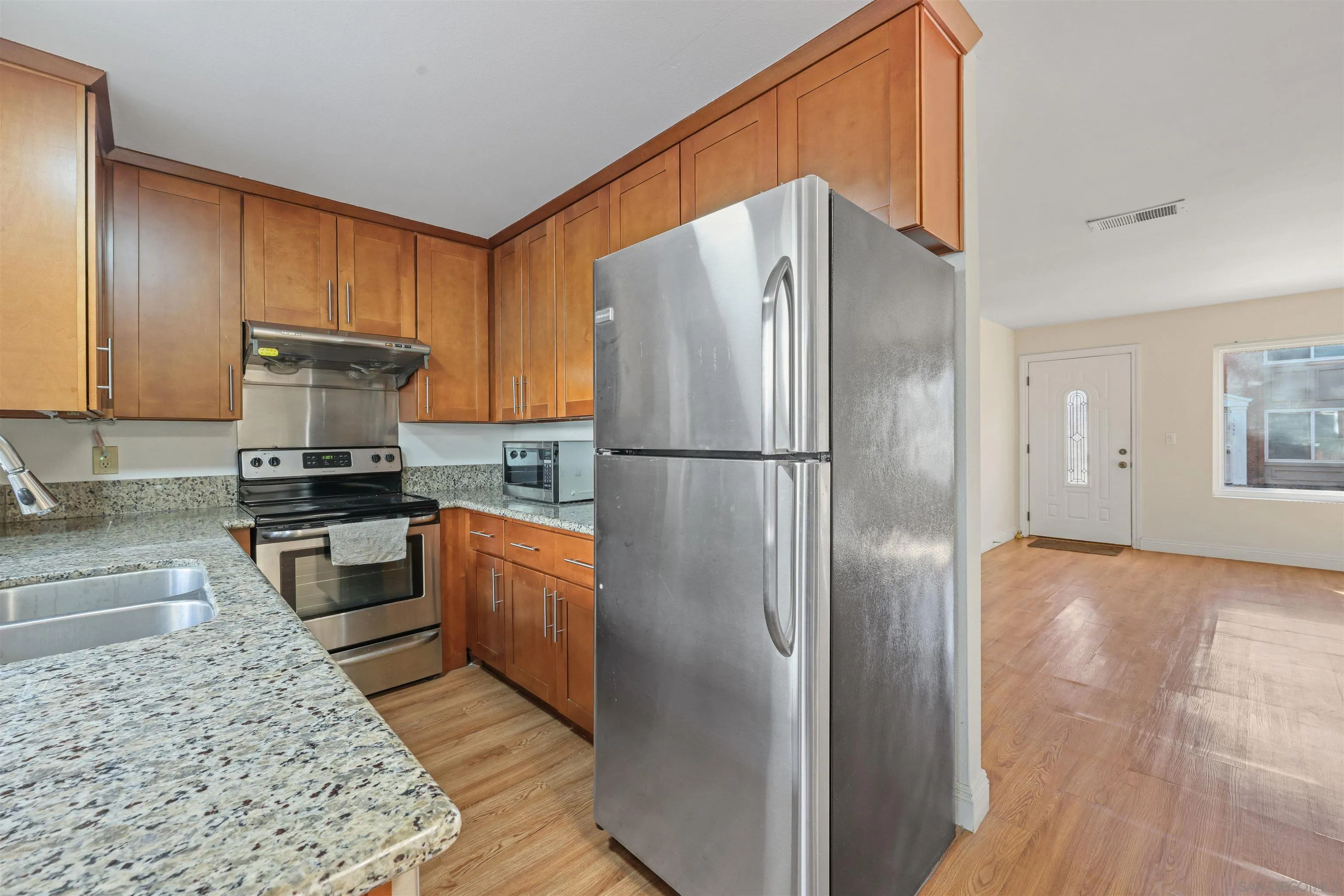 1652 Summertime Drive El Cajon, CA 92021 - Photo 6 of 23 a kitchen with a refrigerator and a stove
