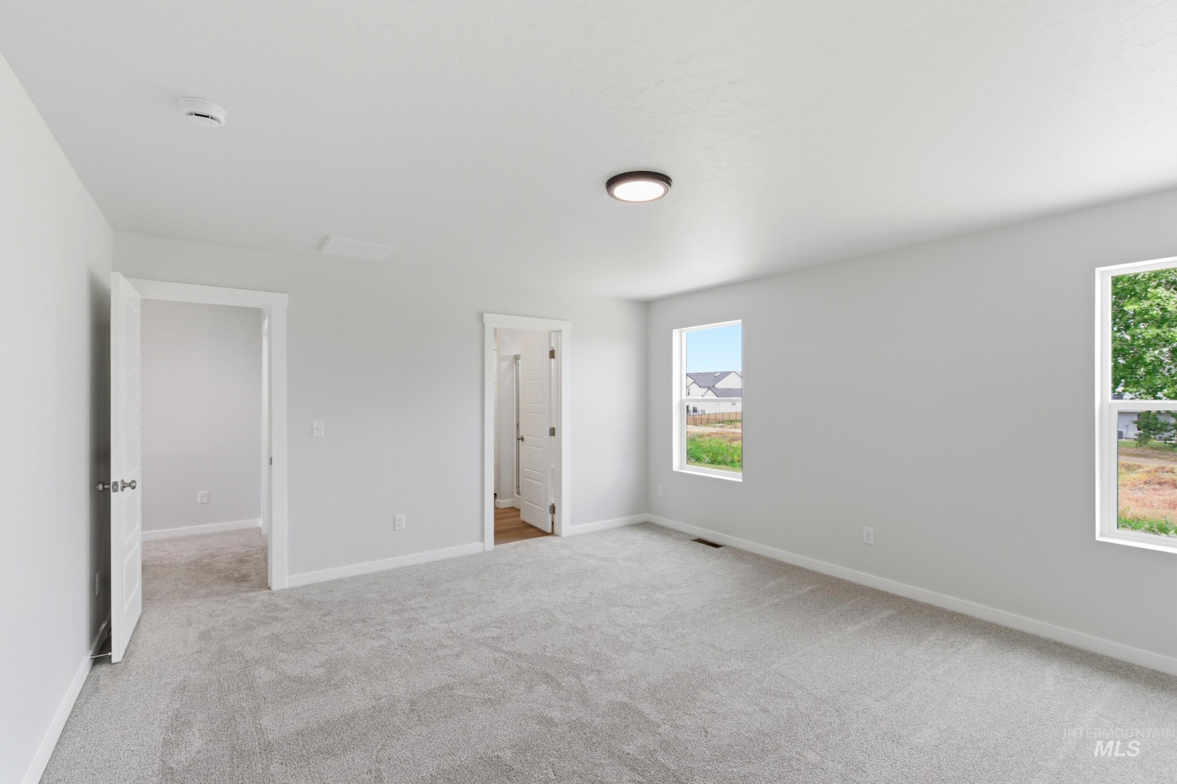 12829 Decatur Street Nampa, ID 83651 - Photo 28 of 33 Spacious room featuring light gray wall paint and matching gray carpet flooring