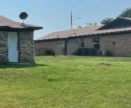 a view of a backyard with a table and chairs