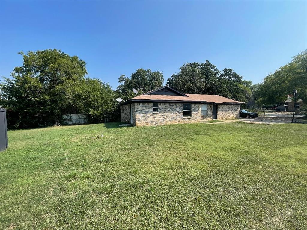 5338 Flamingo Road Fort Worth, TX 76119 - Photo 5 of 11 a front view of a house with a yard
