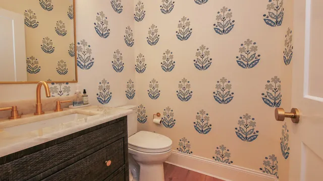 a bathroom with a granite countertop toilet sink vanity mirror and painting on the wall