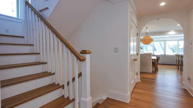 a view of an entryway with wooden floor and windows