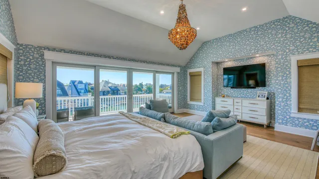 a large bedroom with a bed and glass window