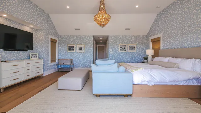 a bedroom with furniture and a flat screen tv