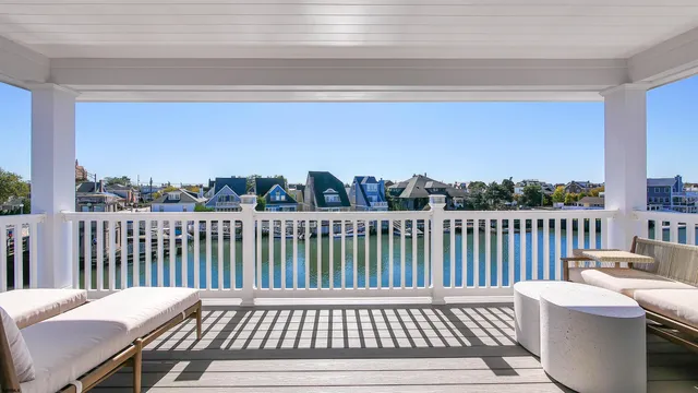 a view of a wooden chairs on the roof deck