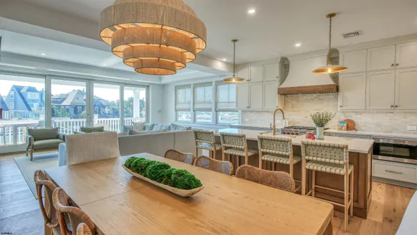 a very nice looking dining room with a large window and dining table