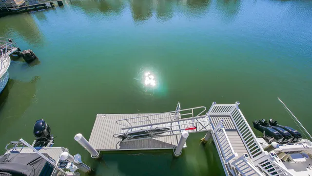 a view of a deck with chair and lake view