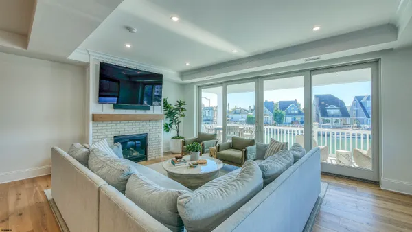 a kitchen with stainless steel appliances granite countertop a stove a refrigerator a sink dishwasher with a dining table and chair
