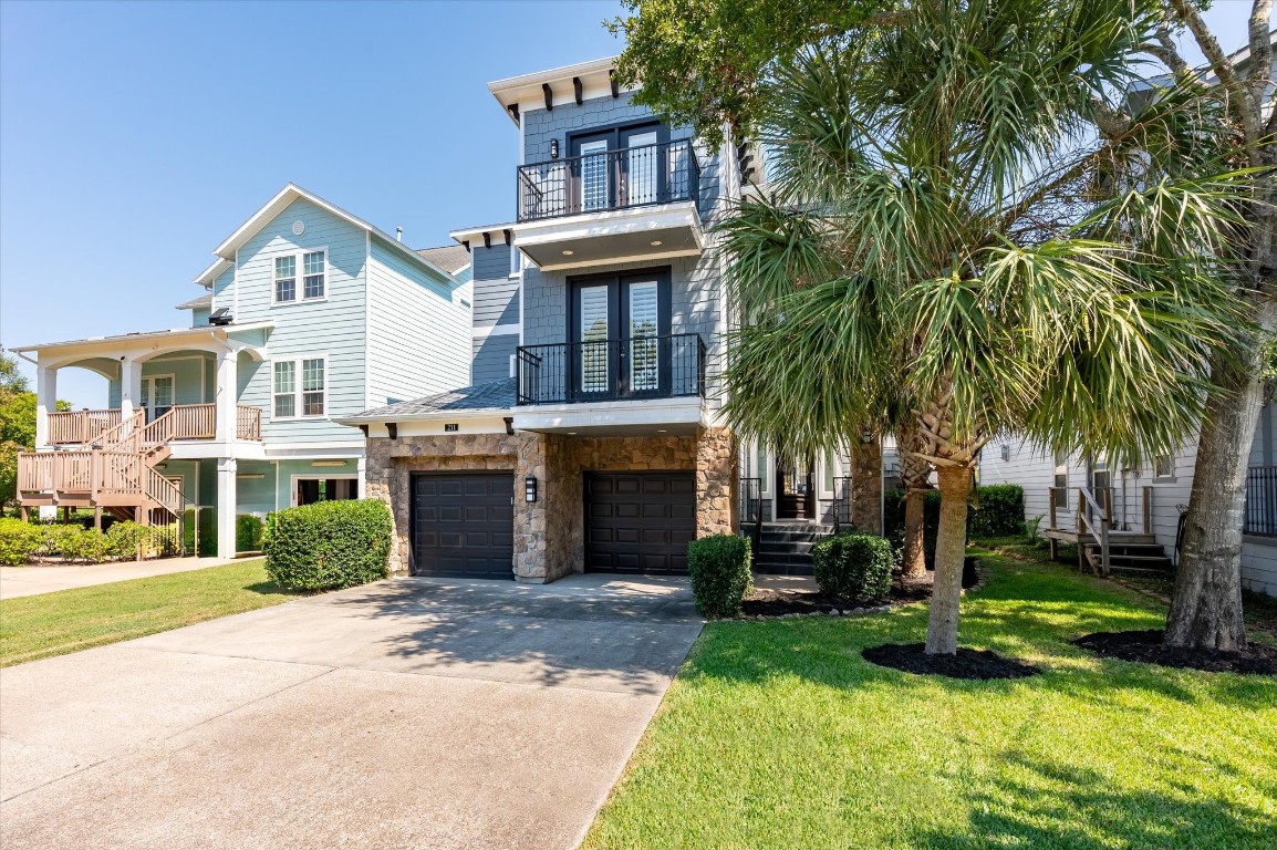 211 Valmar Street Kemah, TX 77565 - Photo 14 of 50 a front view of a house with a yard and palm trees