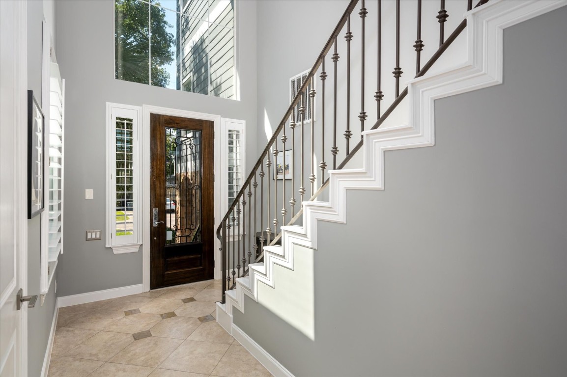 211 Valmar Street Kemah, TX 77565 - Photo 18 of 50 a view of staircase with lots of frames on wall and a window