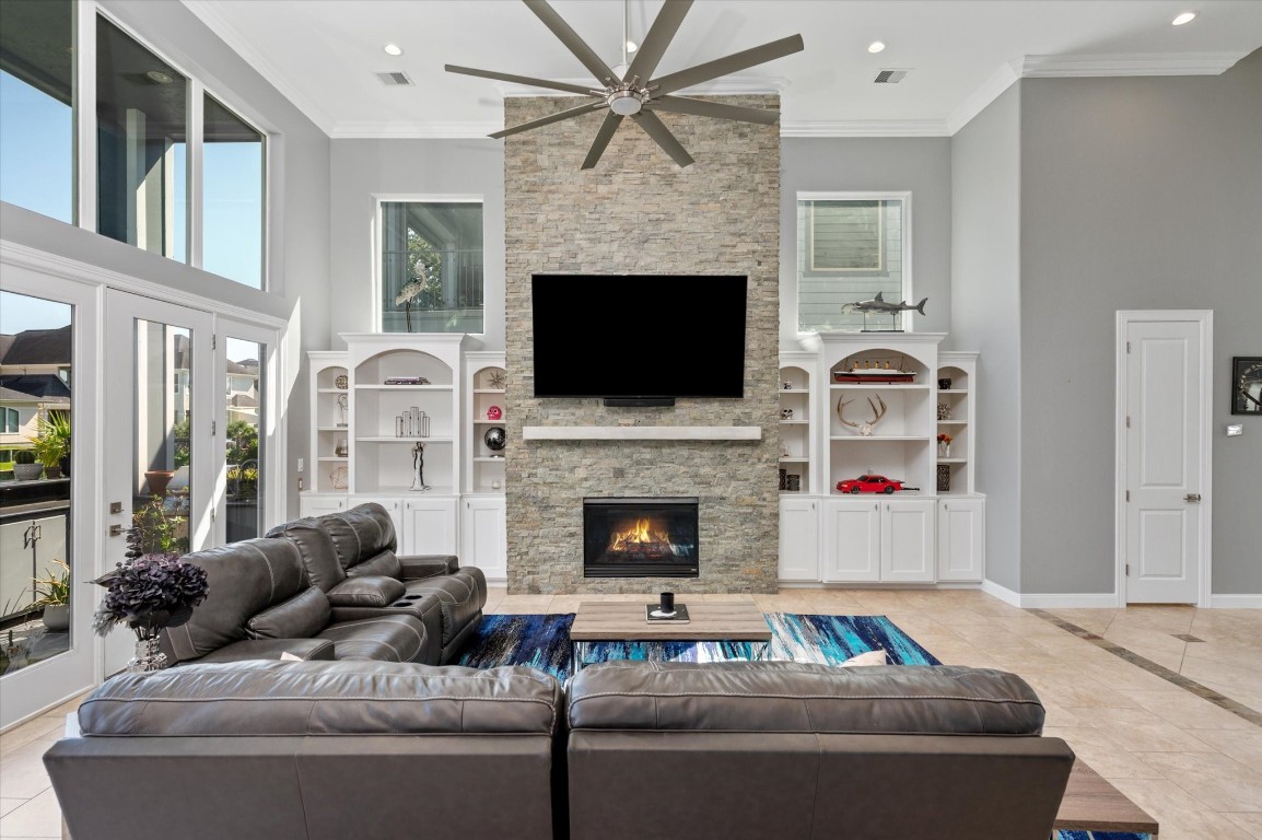 211 Valmar Street Kemah, TX 77565 - Photo 21 of 50 a living room with furniture a fireplace and a flat screen tv