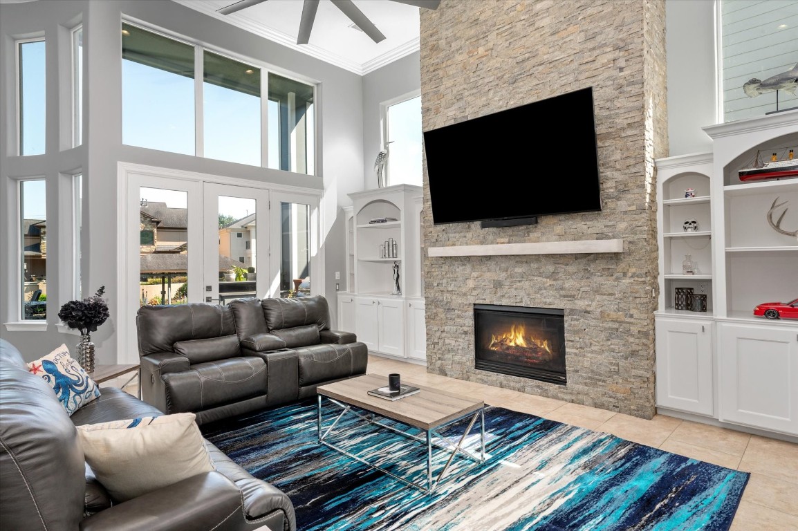 211 Valmar Street Kemah, TX 77565 - Photo 22 of 50 a living room with furniture a flat screen tv and a fireplace