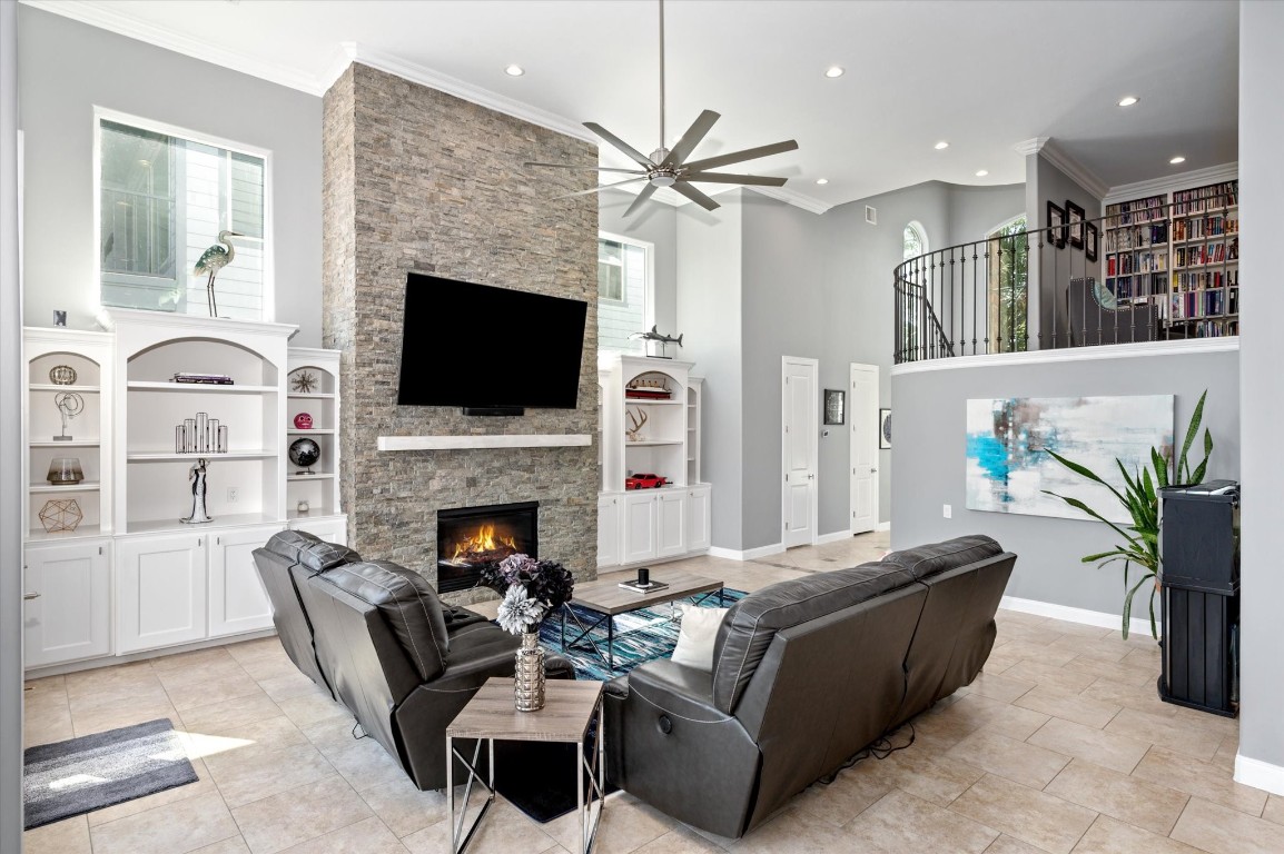 211 Valmar Street Kemah, TX 77565 - Photo 23 of 50 a living room with furniture a fireplace and a flat screen tv