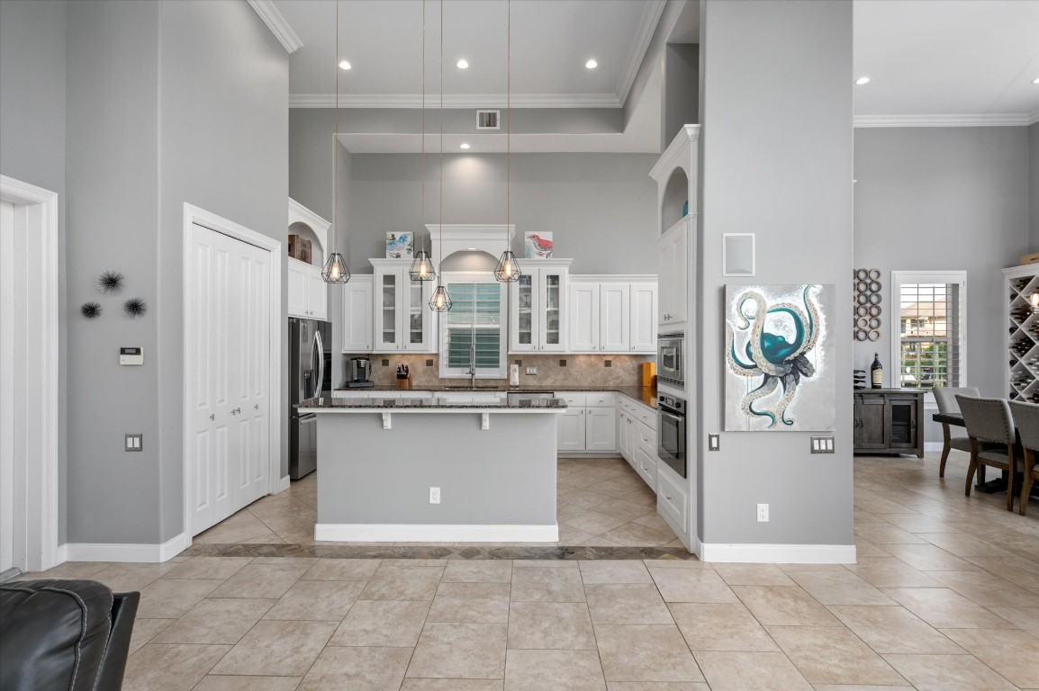 211 Valmar Street Kemah, TX 77565 - Photo 25 of 50 a view of a kitchen with refrigerator and furniture