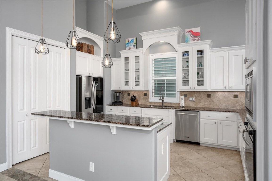 211 Valmar Street Kemah, TX 77565 - Photo 26 of 50 a kitchen with stainless steel appliances granite countertop a sink and a refrigerator