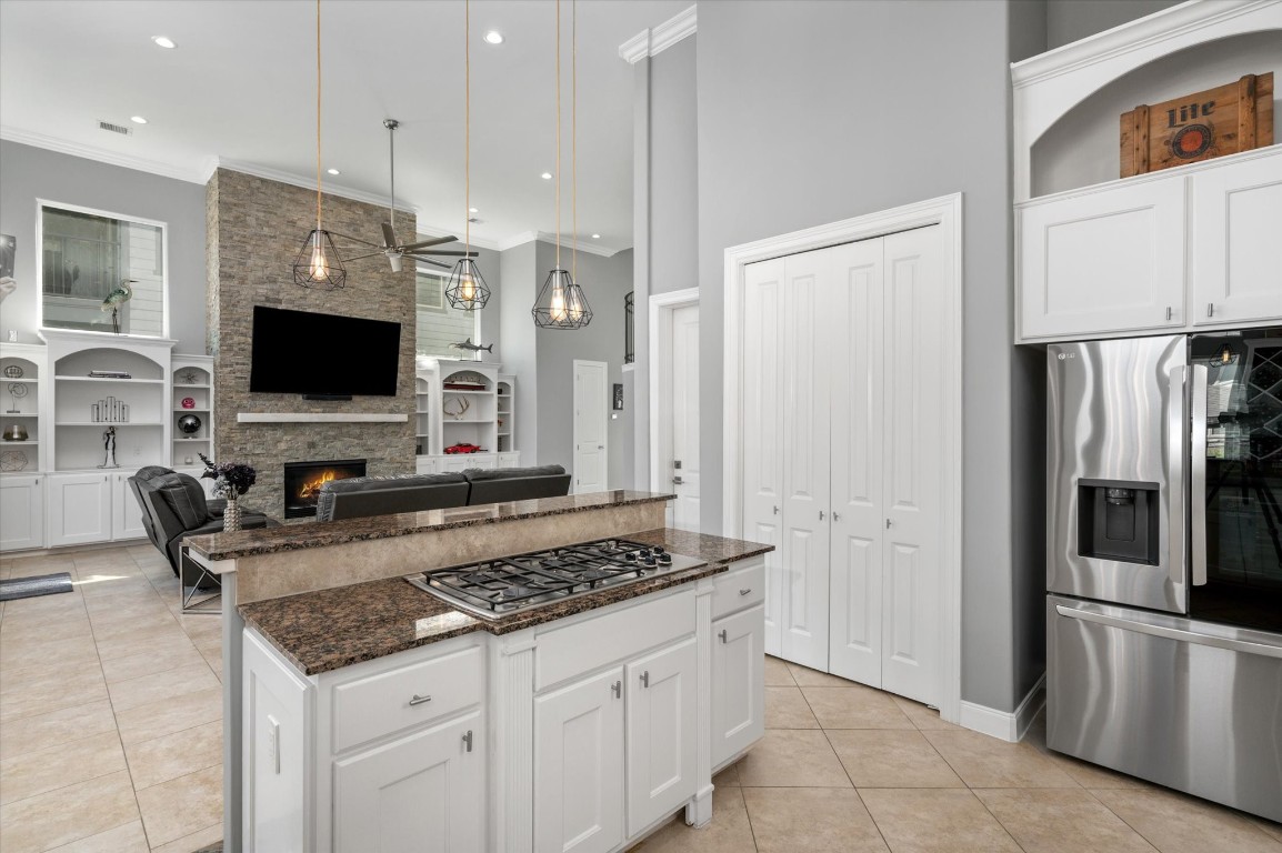 211 Valmar Street Kemah, TX 77565 - Photo 28 of 50 a kitchen with stainless steel appliances granite countertop a refrigerator and a stove top oven