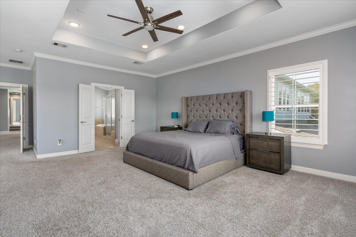 211 Valmar Street Kemah, TX 77565 - Photo 48 of 50 a bedroom with a large bed and a chandelier