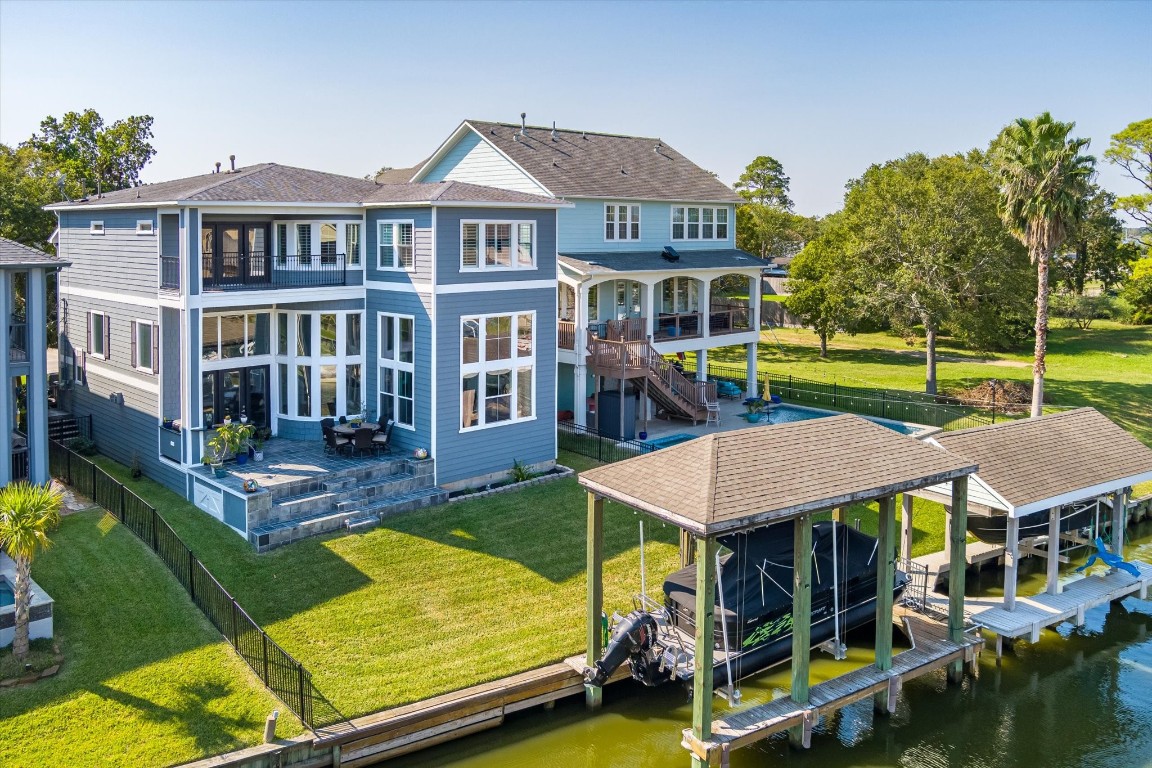211 Valmar Street Kemah, TX 77565 - Photo 7 of 50 an aerial view of a house with swimming pool lawn chairs and a yard