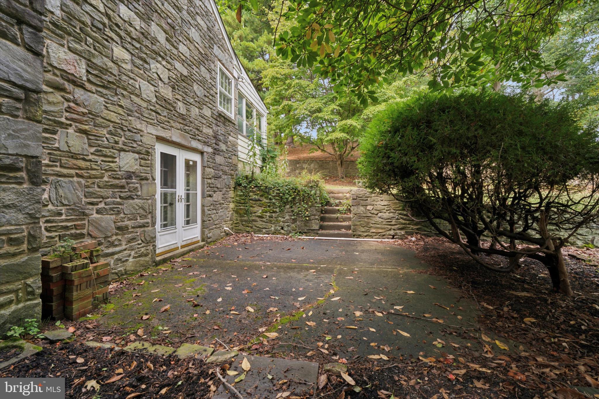 403 Atwater Road Broomall, PA 19008 - Photo 34 of 35 Charming stone patio nestled in nature.