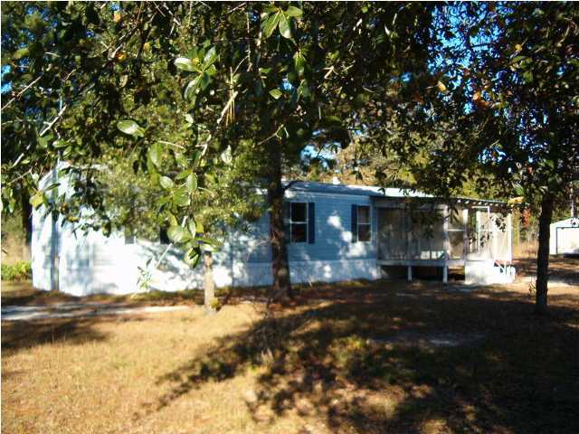 135 Henderson Road DeFuniak Springs, FL 32433 - Photo 1 of 14 a view of a yard with large tree