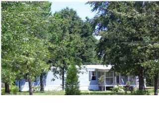 135 Henderson Road DeFuniak Springs, FL 32433 - Photo 2 of 14 a front view of a house with a yard