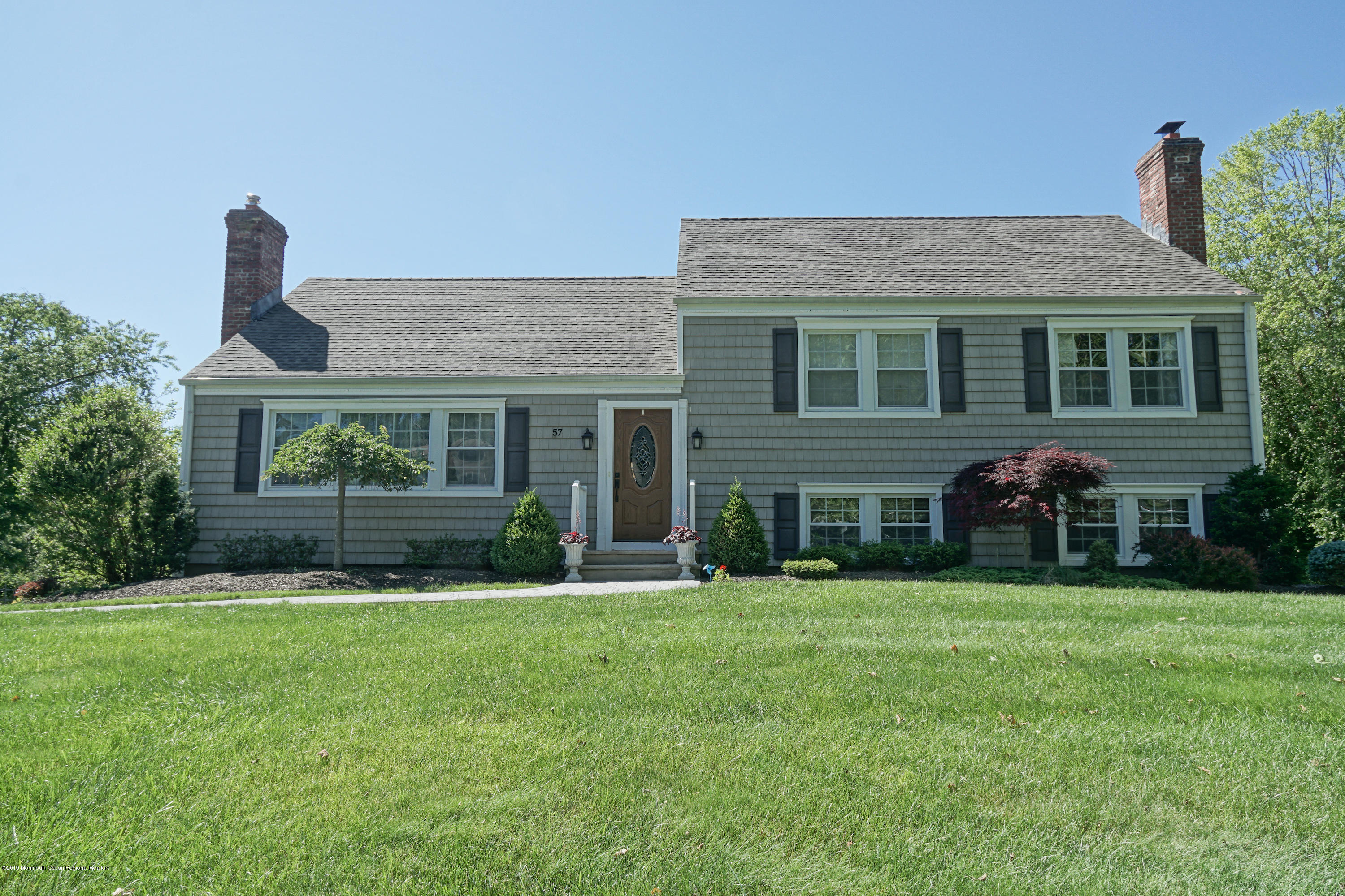 57 Ballantine Road Middletown, NJ 07748 - Photo 1 of 24 a front view of a house with a garden