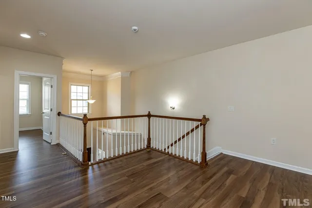 a view of staircase with wooden floor and window