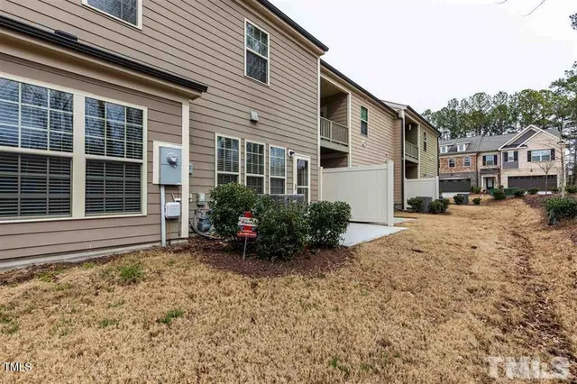 a view of a house with a yard and sitting area