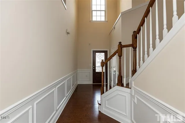 a view of hallway with stairs and wooden floor