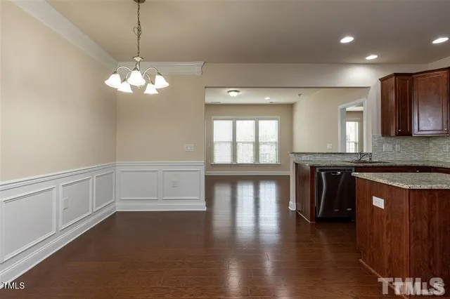 a view of a kitchen with a sink and dishwasher wooden floor
