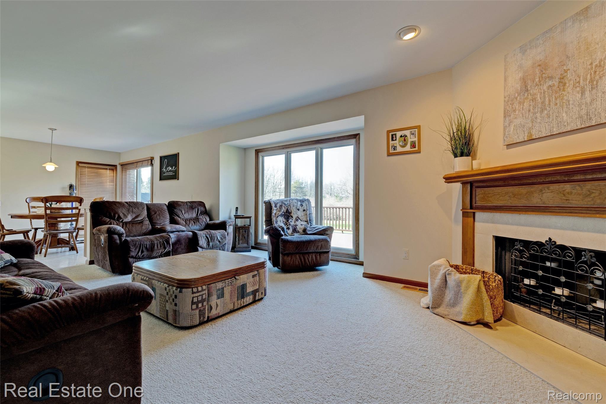 6400 Oakhill Road Ortonville, MI 48462 - Photo 23 of 82 Living room with light colored carpet and a fireplace with flush hearth