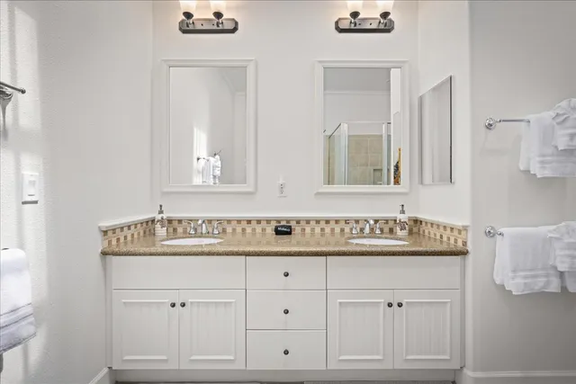 a bathroom with a sink vanity and mirror
