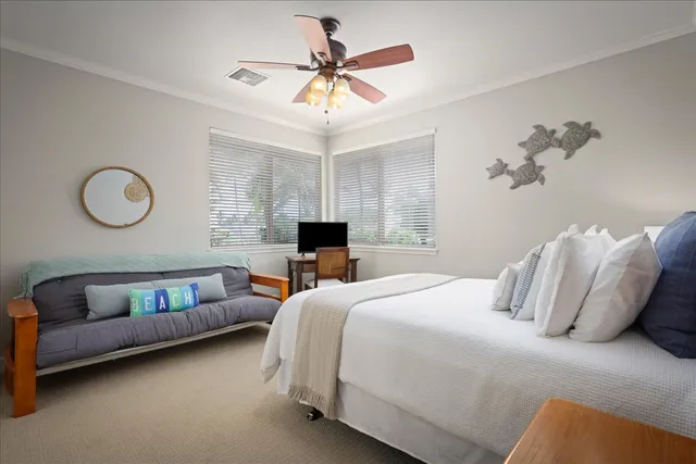 a bedroom with a bed couch and window