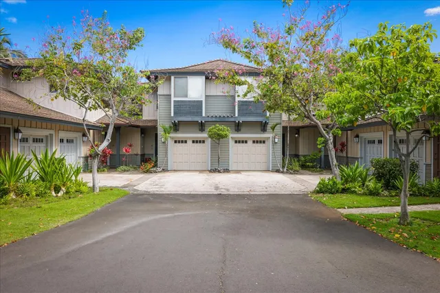 a front view of a house with a yard and a garage
