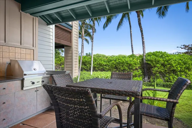 a view of an outside dining space with a table and chairs